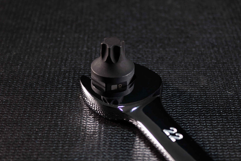 Wrench over the hex base of a stubby impact torx bit.