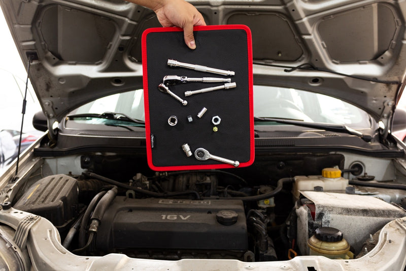 Holding a magnetic tool mat vertically with fasteners and tools on it