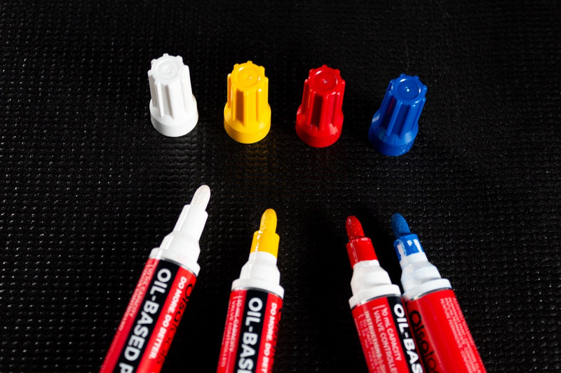Four Olsa Tools industrial paint pens for mechanics with exposed tips.